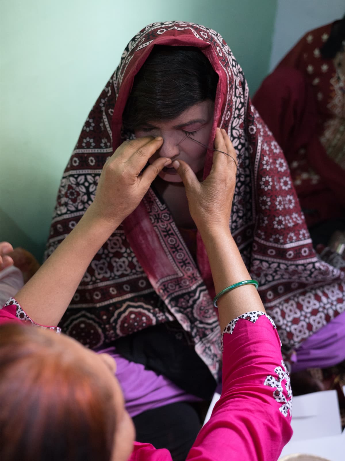 A Sindhi *chela’s* nose is being pierced by her guru