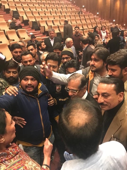 Audience members take a selfie with ex-CJP Saqib Nisar.