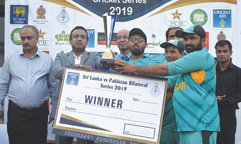 COLOMBO: Manusha Nanayakkara, Member of National Parliament Sri Lanka, and Syed Sultan Shah, Chairman Pakistan Blind Cricket Council prsent the winner’s trophy to Pakistan blind cricket team captain Nisar Ali here on Monday. COLOMBO: Manusha Nanayakkara, Member of National Parliament Sri Lanka, and Syed Sultan Shah, Chairman Pakistan Blind Cricket Council prsent the winner’s trophy to Pakistan blind cricket team captain Nisar Ali here on Monday.