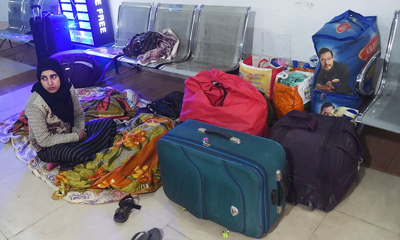 A stranded Indian passenger travelling with the Samjhota Express, also called the Friendship Express, that runs between Delhi and Attari, sits at the waiting area at Lahore railway station on February 28. ─ AFP