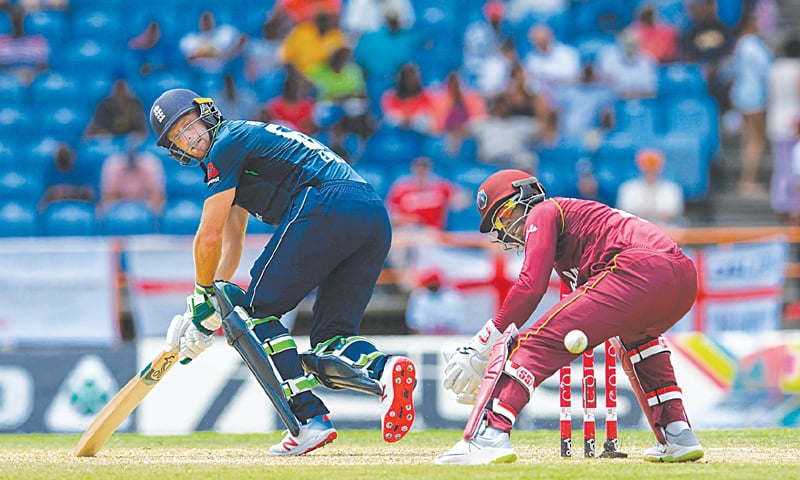 ENGLAND batsman Jos Buttler plays a shot past 
West Indies wicket-keeper Shai Hope during the fourth One-day International at the Grenada National Cricket Stadium.—AFP