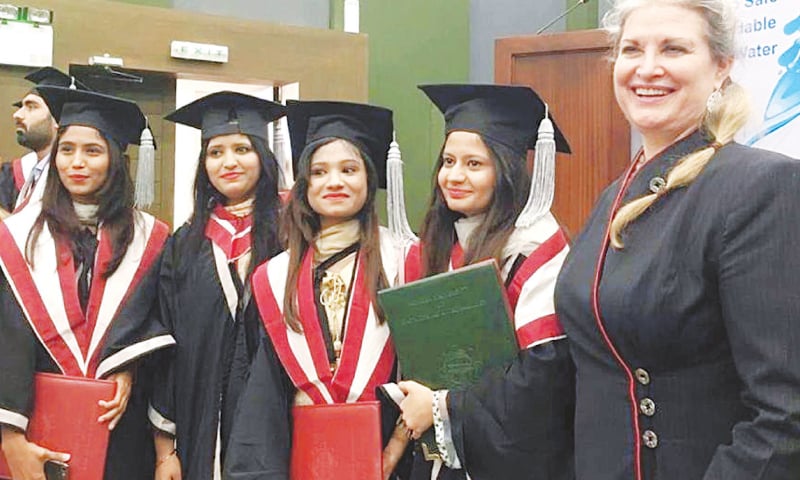 US Consul General JoAnne Wagner is all smiles as she poses for a group photo with fresh graduates at MUET on Friday.—PPI