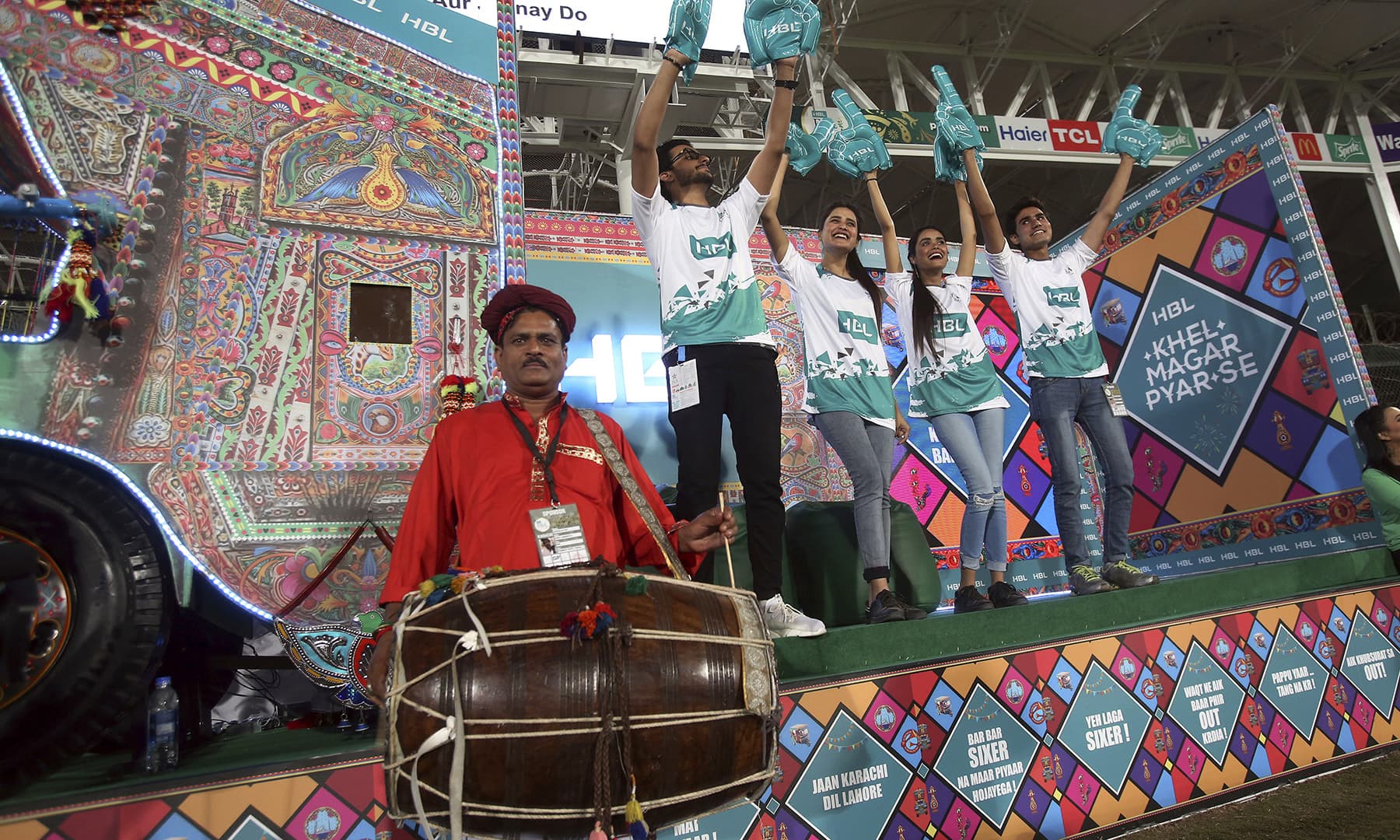 Cricket fans dance on traditional drum beat. — AP