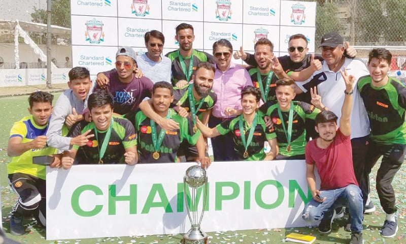 KARACHI: Members of the winning team of the Road to Anfield tournament pose with the trophy.