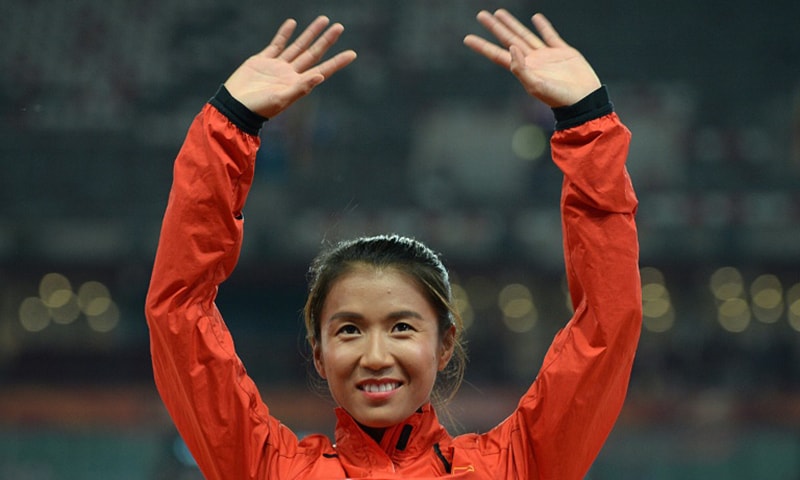 China's Liu Hong becames the first woman to dip under the four-hour mark.— AFP