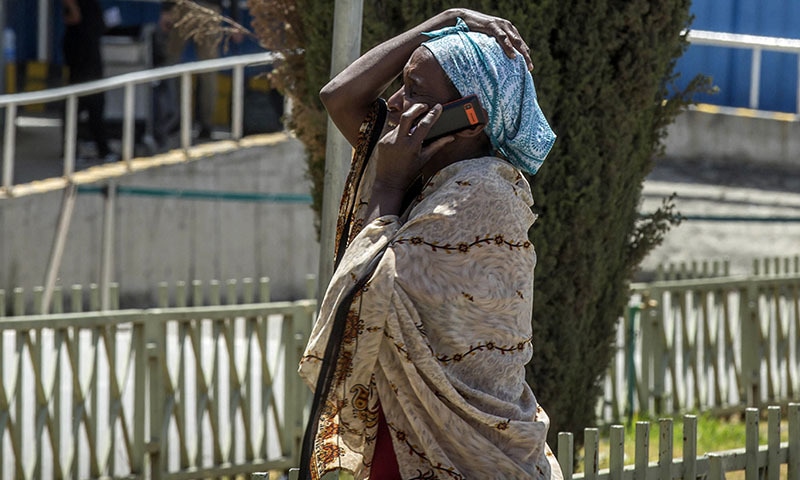 A family member of a victim involved in the plane crash talks on a mobile phone at Addis Ababa international airport. — AP