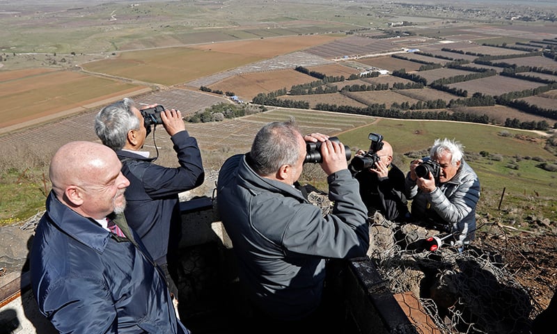 In this file photo taken on February 5, 2019 Avigdor Lieberman, Yisrael Beiteinu party leader and Israel's former defence minister, looks through binoculars during a visit to a looking point in Mount Bental in the Israeli-occupied Golan Heights, as part of his campaign for the upcoming Israeli election. 
The US no longer refers to the Golan Heights as an "Israeli-occupied" territory in its latest annual human rights report, published on March 13, 2019. &mdash; AFP