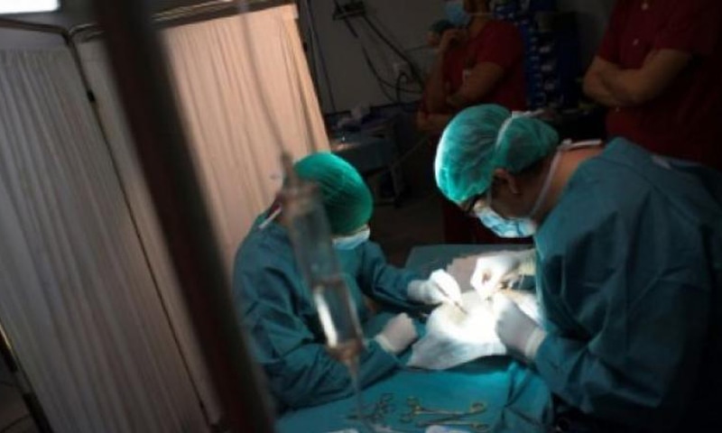 Two surgeons, making arrangements for a surgery, are seen in this file photo. —AFP/File