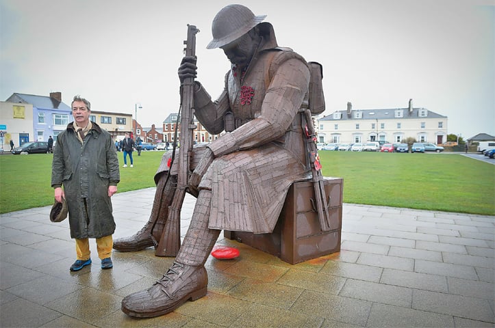 Seaham: Former UK Independence Party leader and Brexit spearhead Nigel Farage poses by a war memorial during the first leg of the March To Leave march on Saturday.—AFP