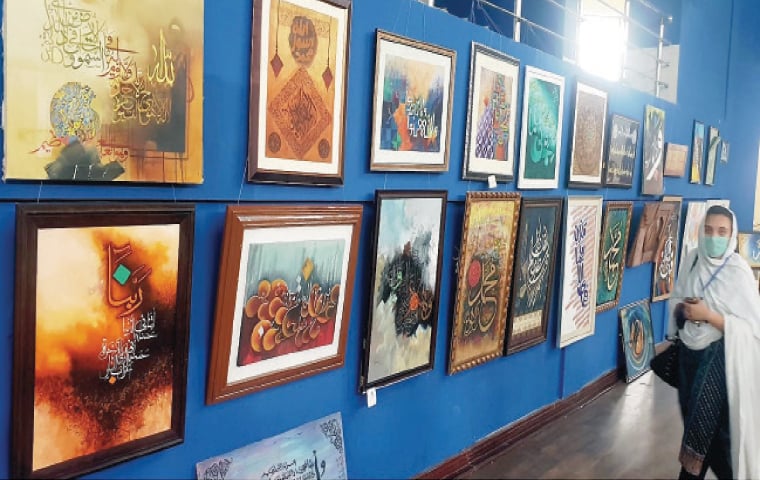 A visitor at the calligraphy exhibition in Charsadda on Monday. — Dawn