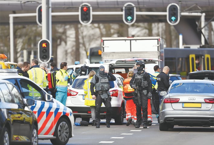 EMERGENCY services personnel stand at the 24 Oktoberplace in Utrecht, where the shooting took place.—AFP