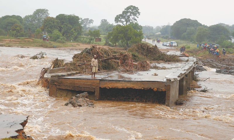 Chimanimani (Zimbabwe): A man looks at a washed away bridge along a river following the cyclone.&mdash;Reuters
