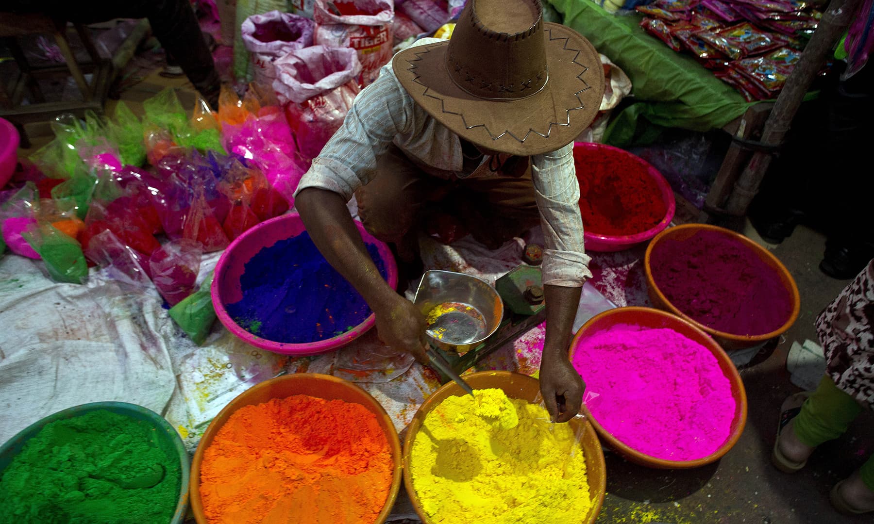 An Indian street vendor sells colored powder a day ahead of Holi, the festival of colors, in Gauhati, India, Wednesday, March 20, 2019. &mdash; AP