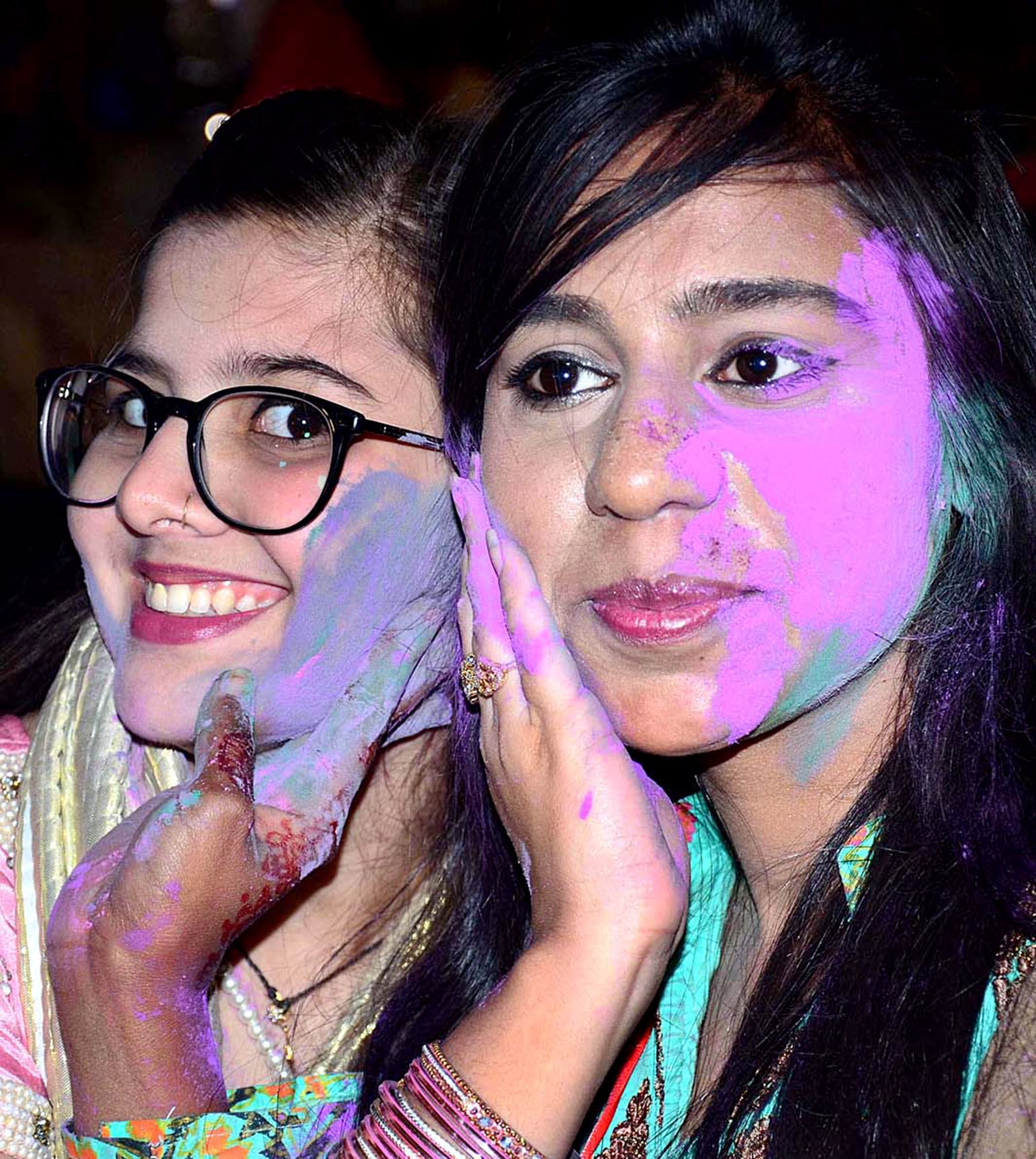 Girls pose for a photo after smearing each other's faces with paint in Hyderabad, Pakistan, on March 20, 2019. &mdash; APP