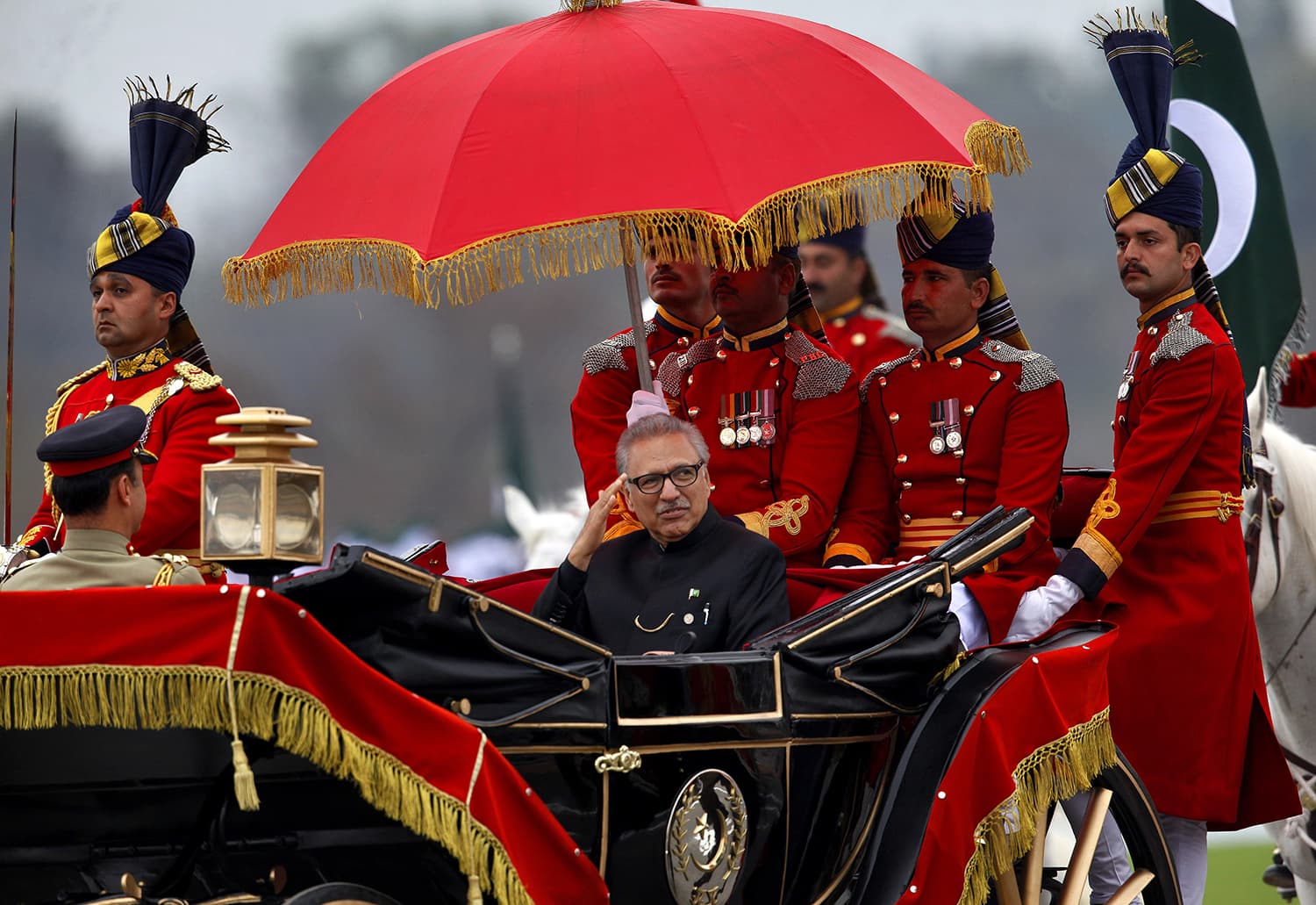 President Arif Alvi salutes as he arrives to attend the Pakistan Day military parade in Islamabad. ─ AP