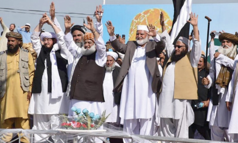 Maulana Fazlur Rehman waves to supporters during a rally in Mirali, North Waziristan, on Sunday. — Dawn