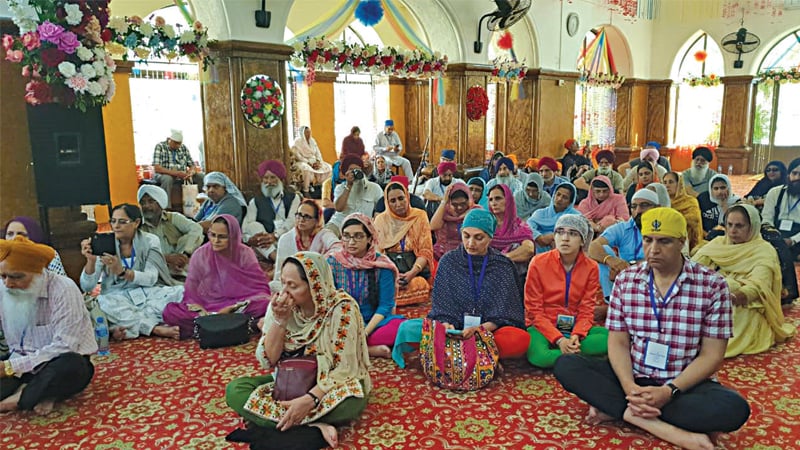 SIALKOT: Sikh pilgrims from the USA, the UK and Canada perform rituals at Gurdwara Babey Di Beri. &mdash; Dawn
