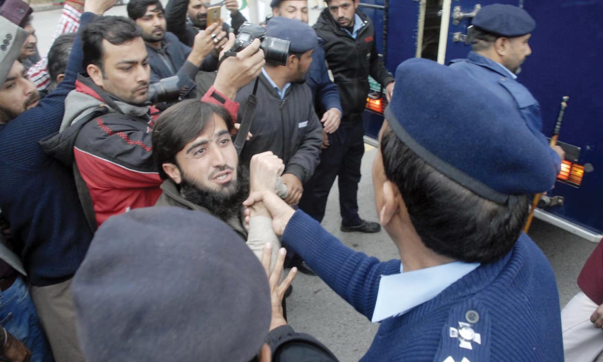 Police personnel arrest a Pashtun Tahafuz Movement activist during a protest outside the National Press Club in Islamabad | Online