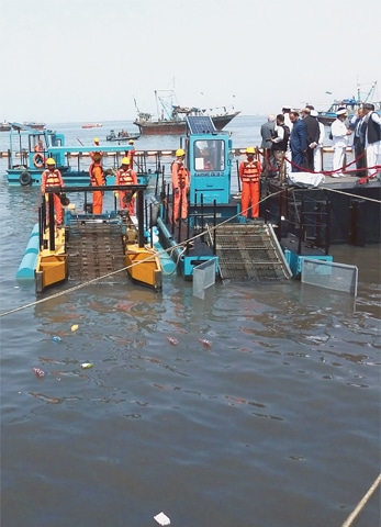 THE barges in action at the Naval Dockyard on Friday.—Photo by the writer