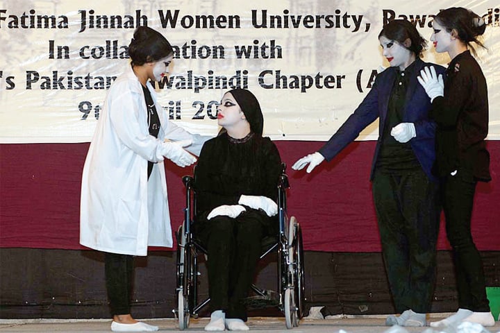Students perform a tableau at Fatima Jinnah Women University on Tuesday. — APP