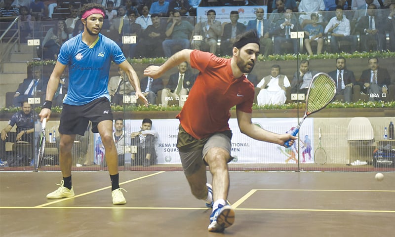 PAKISTAN&rsquo;S Farhan Mehboob hits a return to Mohamed El Sherbini of Egypt during the final at the Mushaf Squash Complex on Wednesday.&mdash;Tanveer Shahzad/White Star