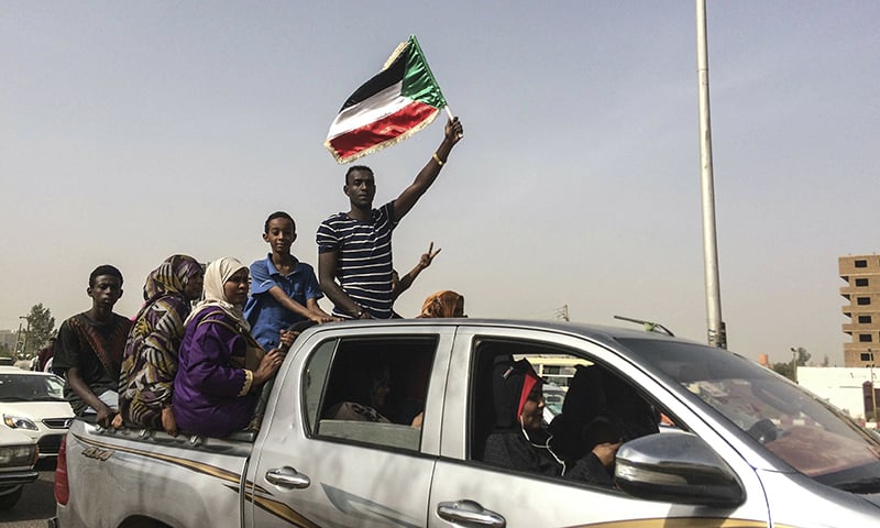 Protesters celebrate in Khartoum, Sudan, after the military forced longtime autocratic President Omar al-Bashir to step down after 30 years in power. ─ AP