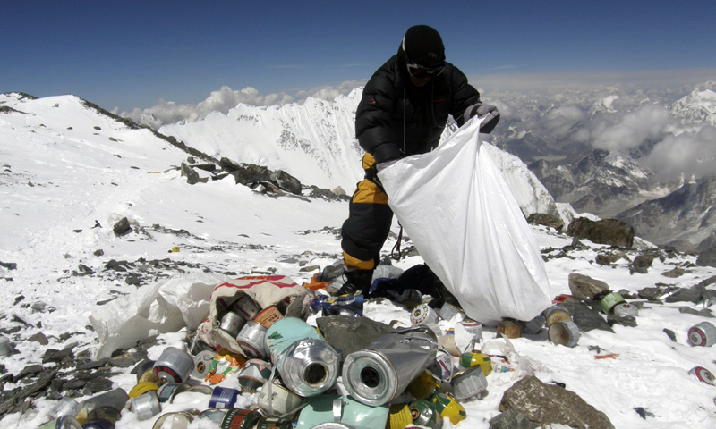 A Nepalese sherpa collects garbage, left by climbers, at an altitude of 8,000 metres during the Everest clean-up expedition at Mount Everest. ─ AFP/File A Nepalese sherpa collects garbage, left by climbers, at an altitude of 8,000 metres during the Everest clean-up expedition at Mount Everest. ─ AFP/File