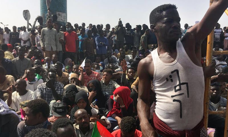 Sudanese protesters gather in the streets of Khartoum as they continue to rally demanding a civilian body to lead the transition to democracy one day after a military council took control of the country. ─ AFP