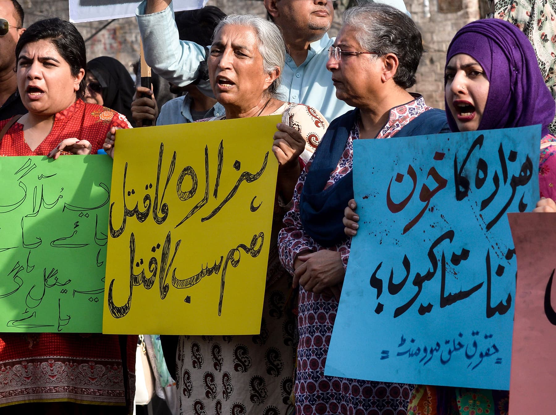 Pakistan human right activists hold placards during a protest in Karachi. — AFP