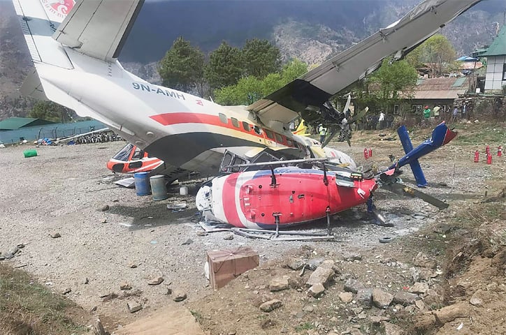 The aircraft pictured after it hit two helicopters during takeoff.—AFP