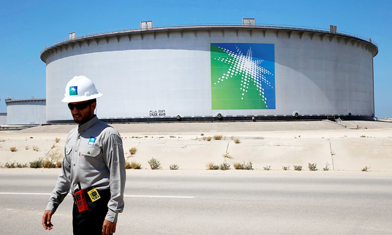 An Aramco employee walks near an oil tank at Saudi Aramco's Ras Tanura oil refinery and oil terminal in Saudi Arabia. — Reuters/File