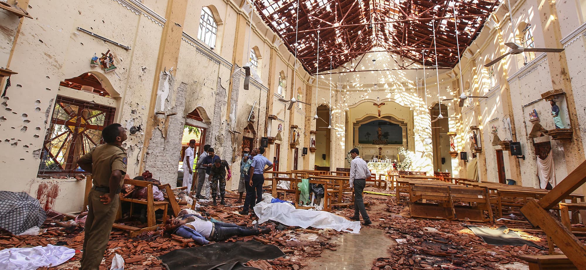 Dead bodies of victims lie inside St. Sebastian's Church damaged in blast in Negombo, north of Colombo, Sri Lanka, Sunday, April 21, 2019.  More than two hundred people were killed and hundreds more injured in eight blasts that rocked churches and hotels in and just outside Sri Lanka's capital on Easter Sunday. (AP Photo/Chamila Karunarathne) — Copyright 2019 The Associated Press. All rights reserved.