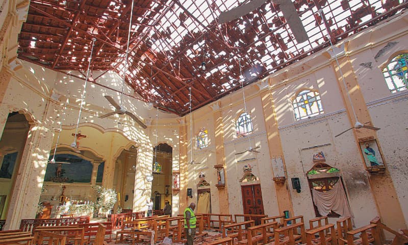 Negombo: An official inspects the site of a blast inside a church.—Reuters