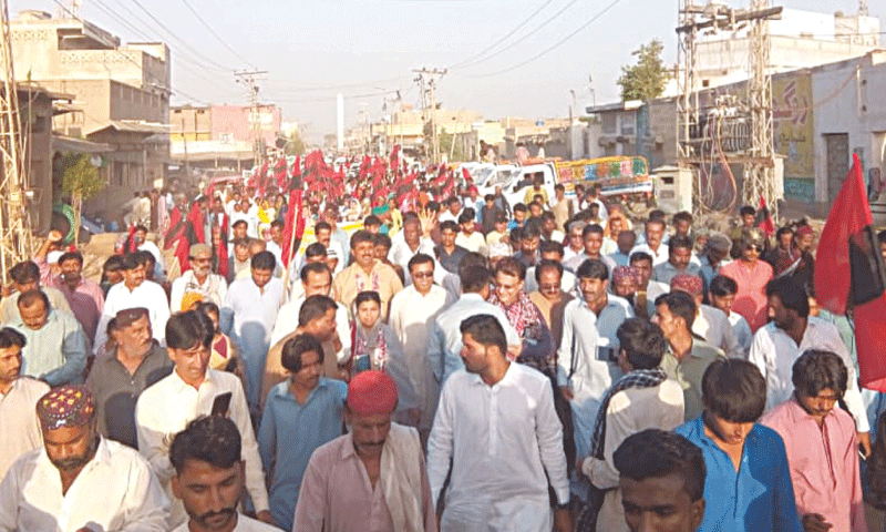 THE rally against water shortage passes through a street of Talhar on Monday.—Dawn