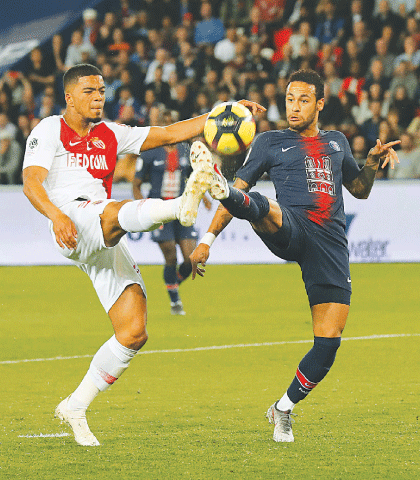 PARIS: PSG&rsquo;s Neymar (R) vies for the ball with Monaco&rsquo;s Robert Navarro during their Ligue 1 match at the Parc des Princes.&mdash;AP