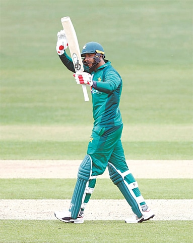IMAD Wasim raises bat after reaching the century.&mdash;PCB