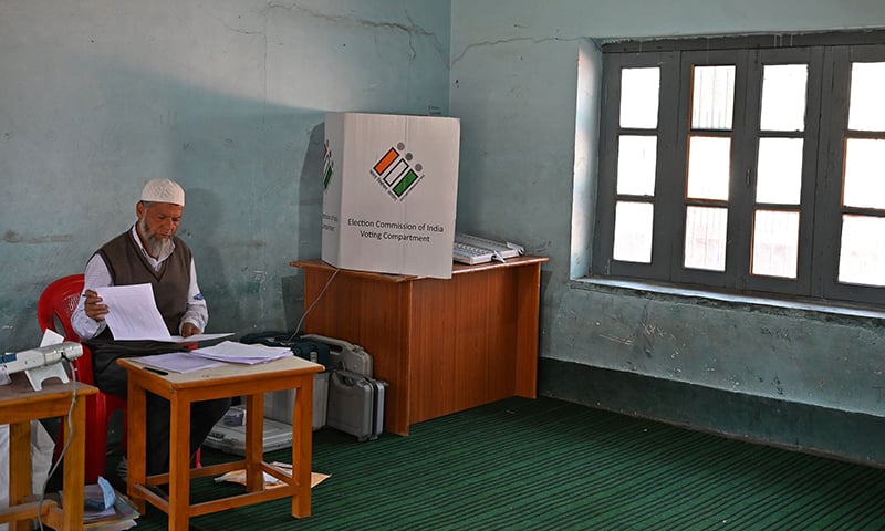 An election official sits inside an empty polling station during the fifth phase of India's general elections in Kashmir's Shopian district. — AFP