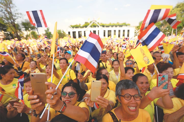 Bangkok: People celebrate outside the balcony of Suddhaisavarya Prasad Hall at the Grand Palace, where King Maha Vajiralongkorn grants a public audience to receive the good wishes of the people. —Reuters