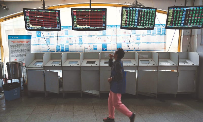 SHANGHAI: Investors monitor stock price movements at a securities company on Monday.  Shanghai stock market sank 5.6pc after Trump’s tweet on increasing tariffs on Chinese goods.