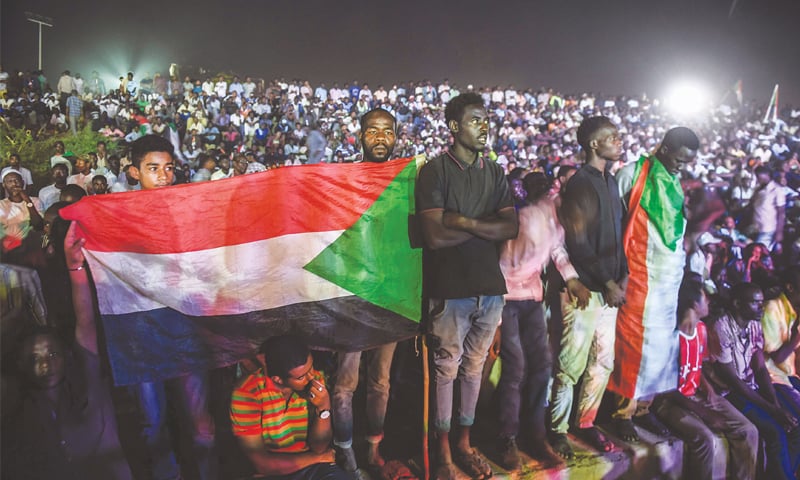 KHARTOUM: Protesters gather during a sit-in outside military headquarters late on Wednesday.—AFP