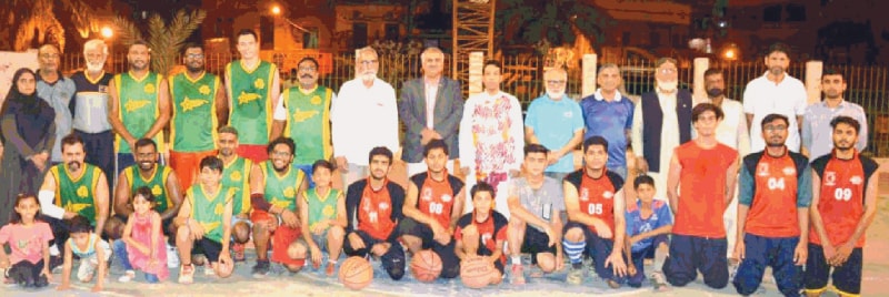 KARACHI: Competing basketball players are seen with chief guest Syed Salahuddin, Deputy Commissioner South, and other officials at the inauguration of the Mahmood Khan Trophy.