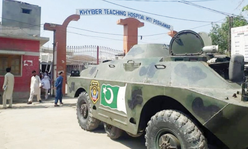 A police APC parked outside the main gate of Khyber Teaching Hospital, Peshawar. — Dawn