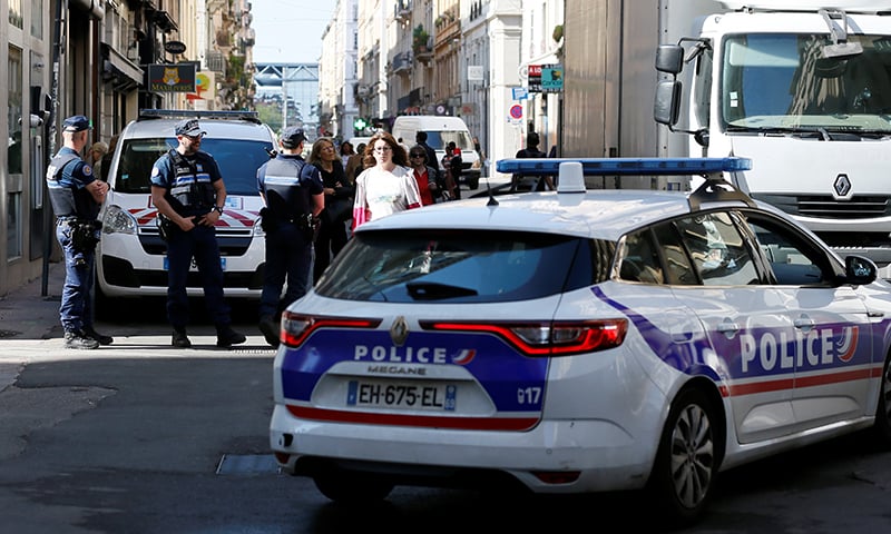 Police patrol the streets during the manhunt of a suspected suitcase bomber in central Lyon. &mdash; Reuters