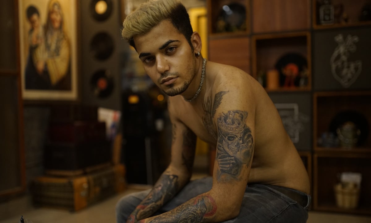 Zain Ali, a regular client at a tattoo studio in Karachi, has an array of tattoos on his arms