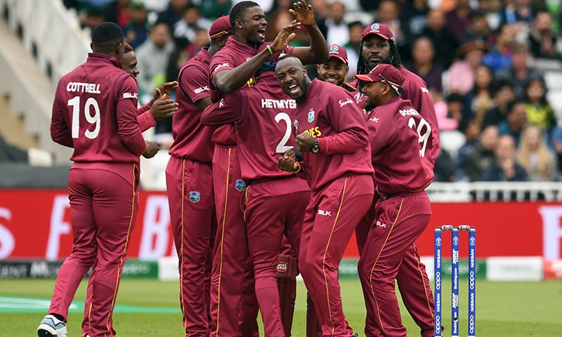 West Indies players including Andre Russell (3R) and captain Jason Holder (4L) celebrate taking the wicket of Pakistan captain Sarfaraz Ahmed during the 2019 Cricket World Cup group stage match between West Indies and Pakistan at Trent Bridge in Nottingham, central England, on Friday. — AFP