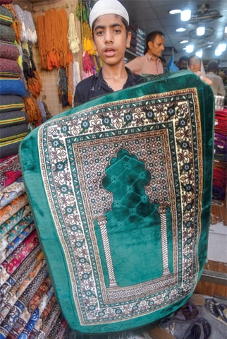A pretty green prayer mat with silken finish.