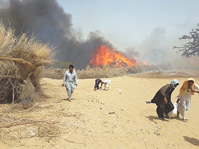 THE fire engulfs the village near Nagarparkar on Monday.&mdash;Dawn