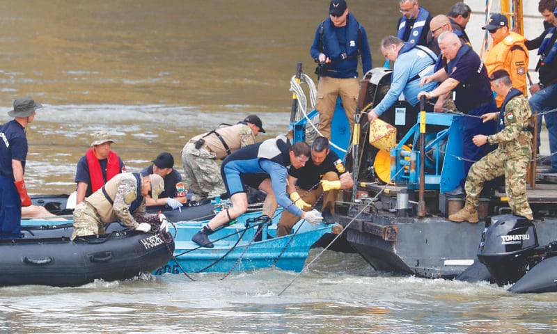 Budapest: Rescuers work on the Danube river where a sightseeing boat capsized after a collision with a river cruise ship.—AP