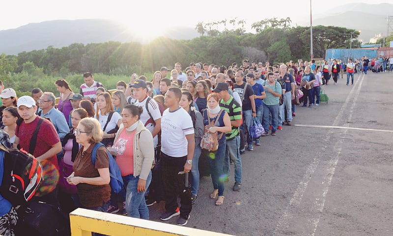 People walk on the Simon Bolivar cross-border bridge between Venezuela and Colombia on Saturday.—Reuters