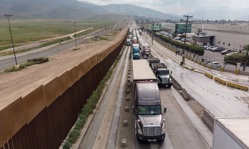 In this file photo taken on April 4, 2019, an aerial view of cargo trucks lining up to cross to the United States near the US-Mexico border at Otay Mesa crossing port in Tijuana, Baja California state, Mexico.—AFP In this file photo taken on April 4, 2019, an aerial view of cargo trucks lining up to cross to the United States near the US-Mexico border at Otay Mesa crossing port in Tijuana, Baja California state, Mexico.—AFP